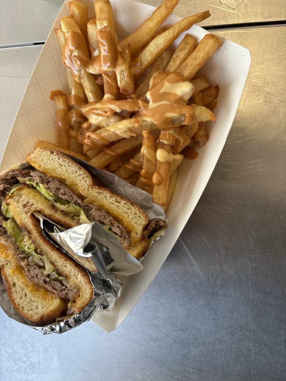 Close-up of a burger with melted cheese and toppings